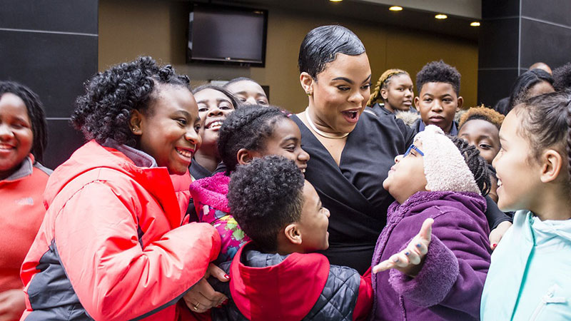 Laurin Talese surrounded by children at the Kimmel Center