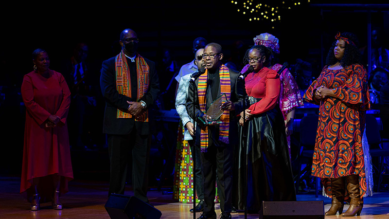 Close up of performers singing on a stage for Soulful Christmas