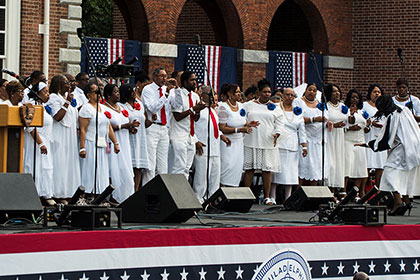 Gospel Singers perform outside on stage in front of Indpendence Hall