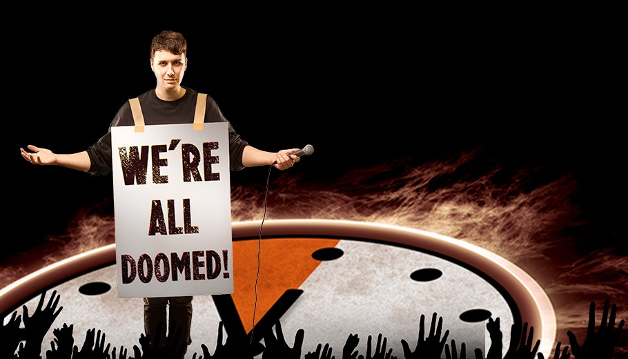 Daniel Howell on stage with a sign that says "We're All Doomed"