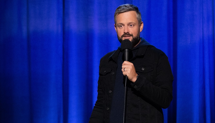 Nate Bargatze standing on stage 