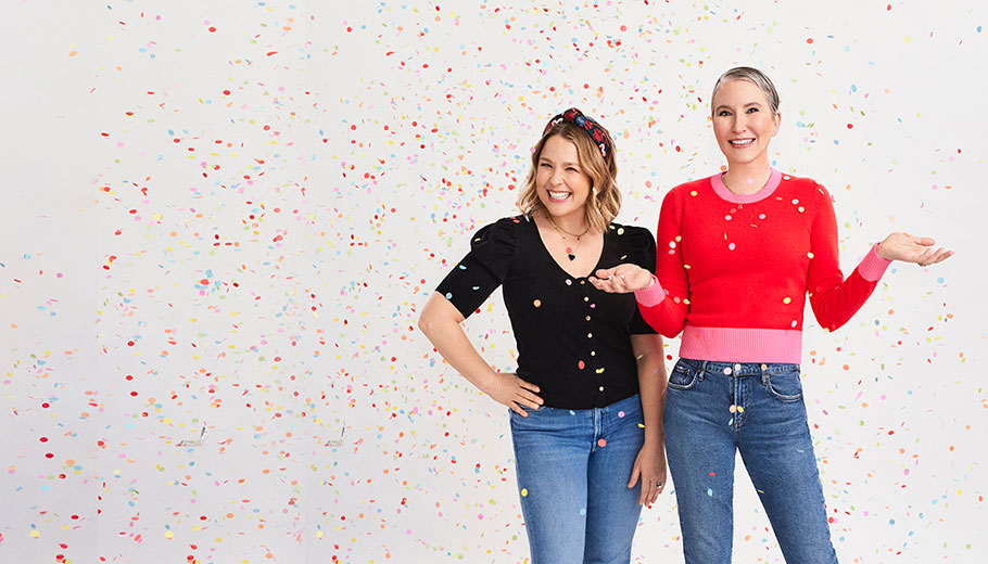 Clea and Joanna in front of a white background with confetti