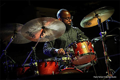 Musician Anwar Marshall playing the drums.