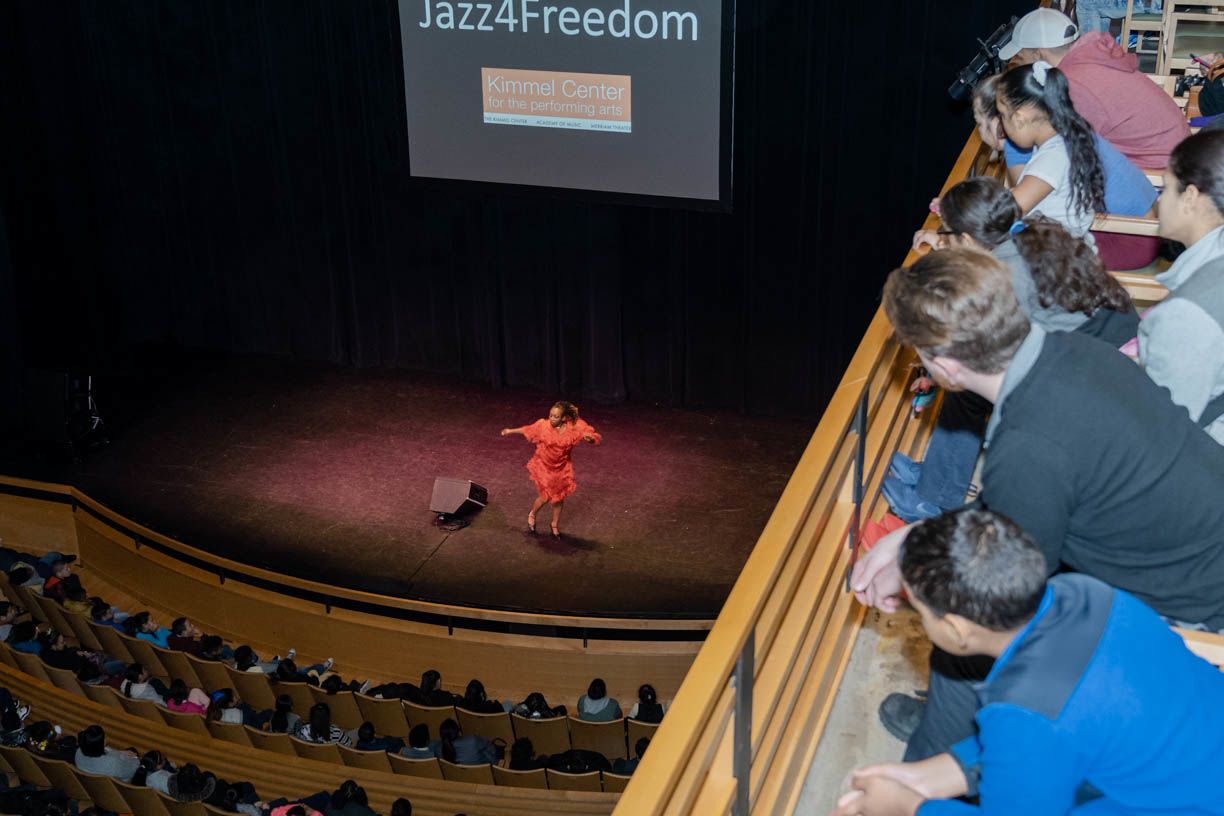 Children look down from a balcony in Perelman Theater watching a tap dancer on stage during a Jazz4Freedom event in 2019.