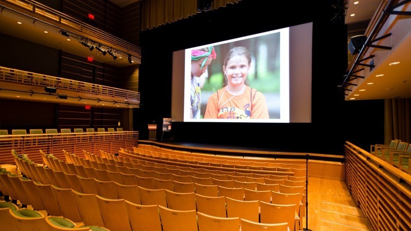 A large screen is set up for a presentation at the Perelman Theater.
