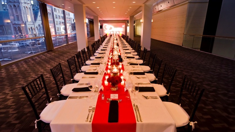 A long dining table is placed at the center of the Lounge for this formal event.