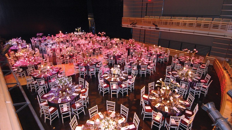 Rows of round tables fill the venue for this event's intimate dinner.